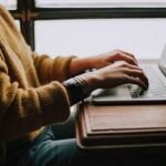 person sitting front of laptop